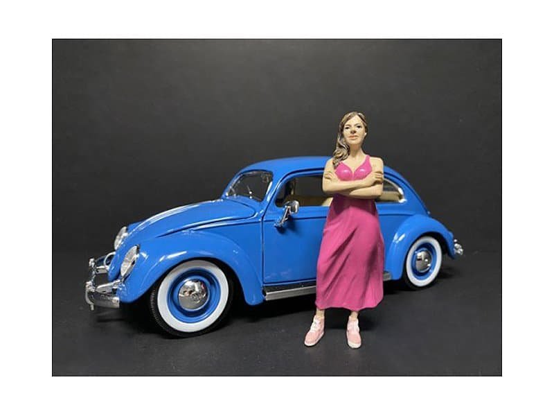 Vintage Blue Car Collectible with Woman Figurine Vintage blue toy car with a detailed woman figurine standing beside it.