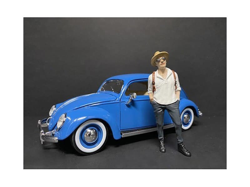Vintage Blue Car and Woman Figurine Detailed miniature of a vintage blue car with a woman figurine standing beside it.