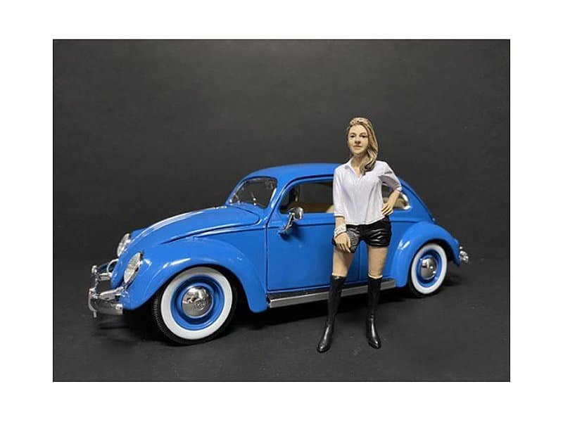 Vintage Blue Classic Car with Woman Figurine Vintage blue classic car with detailed features and a stylish woman figurine standing beside it.