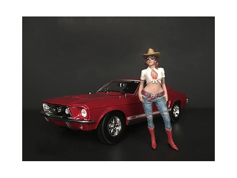Vintage Red Car with Woman Figurine Vintage red muscle car with a female figurine dressed in western attire.