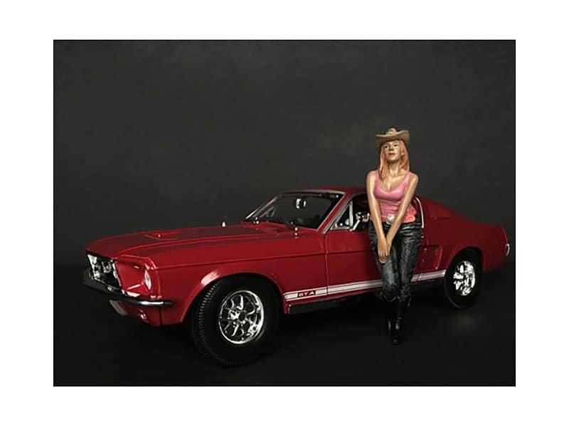 Classic Red Muscle Car with Woman Figurine Vintage red muscle car model with a woman figurine standing beside it.