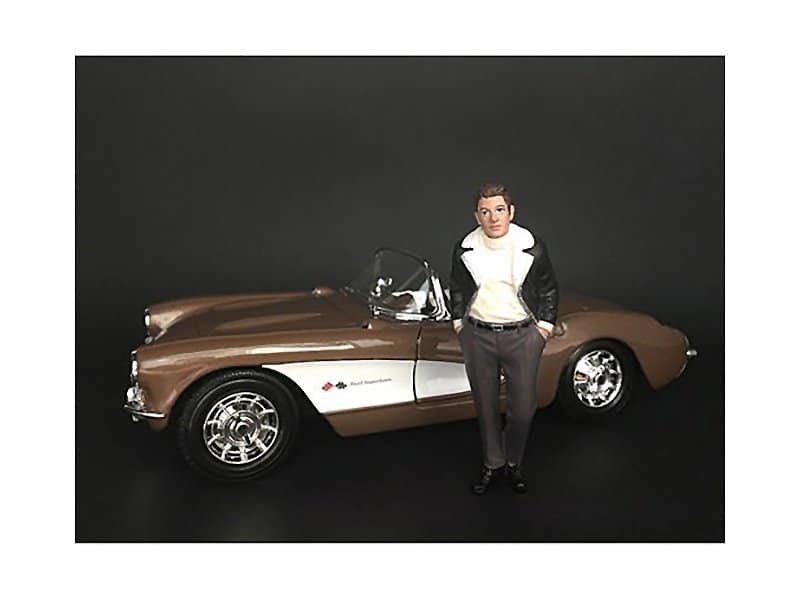 Vintage Corvette with woman in racing jacket and pants. Classic Corvette sports car with a woman standing beside it.