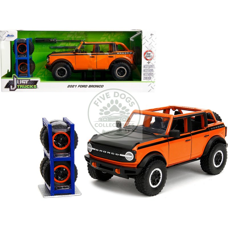 2021 ford bronco open top orange with black stripes and hood with extra wheels "just trucks" series 1/24 diecast model car by jada