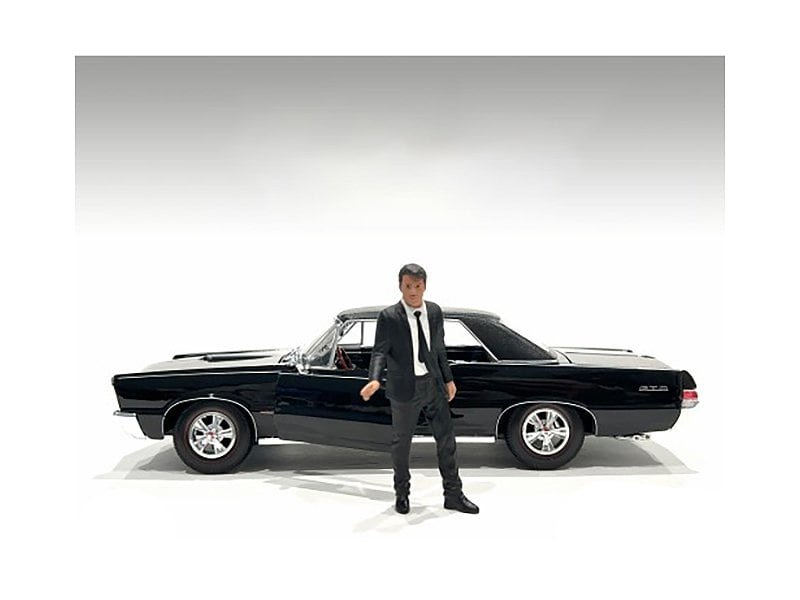 Classic Black Car Collectible with Man Figurine Detailed black vintage car collectible with a stylish man figure standing beside it.