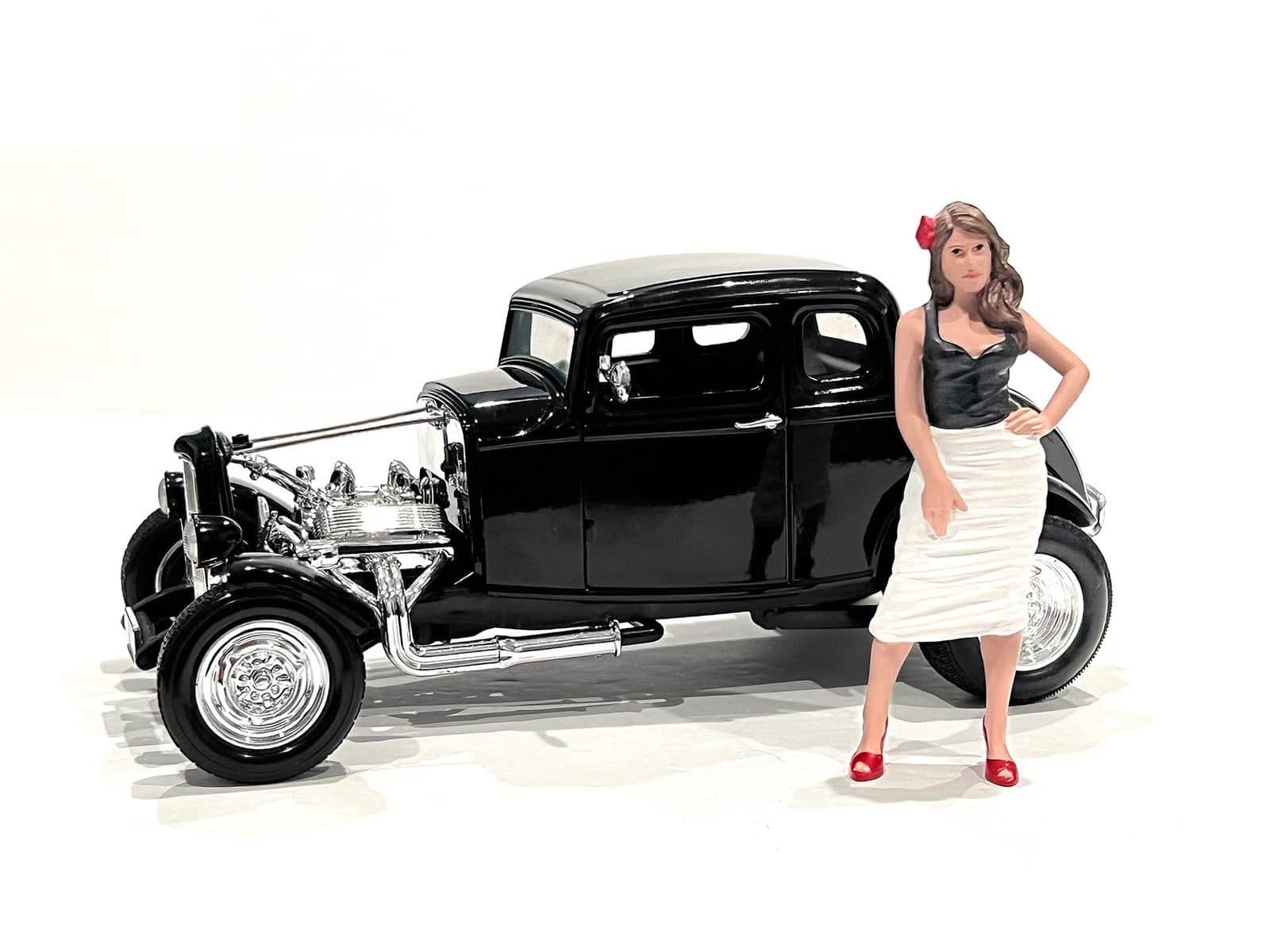 Vintage Black Classic Car with Woman Figurine Vintage black classic car model with detailed chrome accents and a stylish woman figurine in retro a.