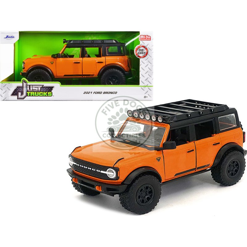 2021 ford bronco orange with black stripes and roof rack "just trucks" series 1/24 diecast model car by jada