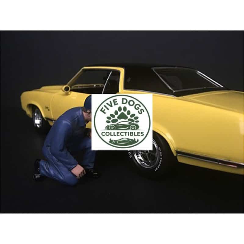 Vintage yellow muscle car with black roof, displayed on a black background.